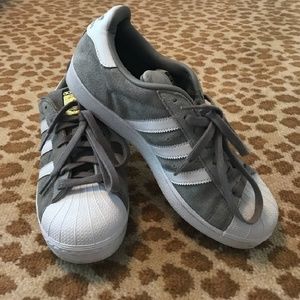 Gray suede shell toe Adidas shoes